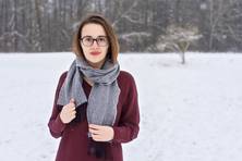 Halbporträt der Komponistin Rachel C. Walker, mit Schal und Mantel in einer Winterlandschaft stehend